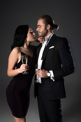 beautiful couple with champagne glasses for valentines day on grey