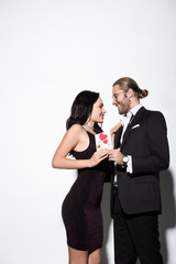 beautiful smiling couple holding valentines day card on white