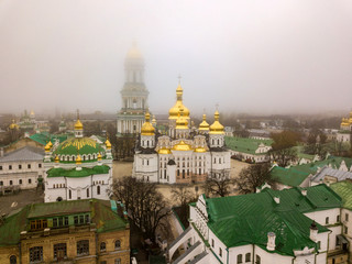 Obraz premium Aerial drone view. Kiev Pechersk Lavra in the fog.