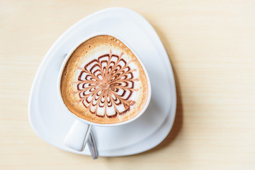 Top view of hot coffee on table / hot cappuccino with nice pattern milk foam 