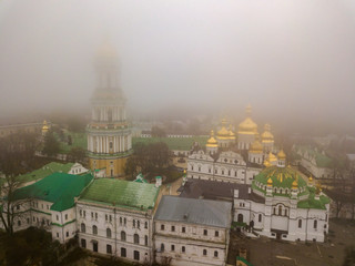 Obraz premium Aerial drone view. Kiev Pechersk Lavra in the fog.