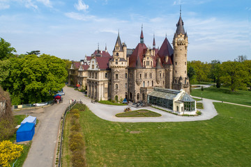 Fototapeta premium Fabulous historic castle in Moszna near Opole, Silesia, Poland. Built in XVII century, extended from 1900 to 1914. One of the best known and most beautiful monuments in Upper Silesia. Aerial view
