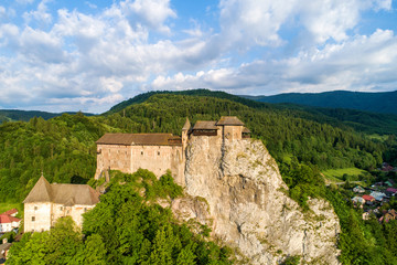 Fototapeta na wymiar Orava castle - Oravsky Hrad in Oravsky Podzamok in Slovakia. Medieval stronghold on extremely high and steep cliff. Aerial view in sunrise light