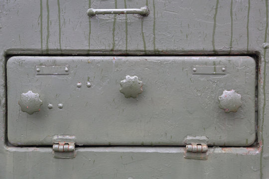 Green textured surface of armored metal with roughness and scratches