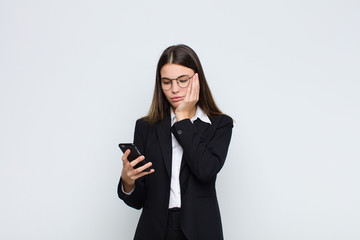 young pretty woman feeling bored, frustrated and sleepy after a tiresome, dull and tedious task,...