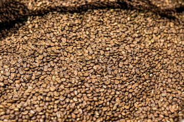 Bunch of freshly roasted coffee arabica beans.