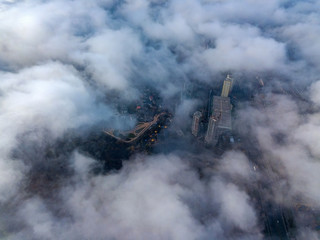 Aerial drone cityscape. Kiev city houses under rare clouds, top view.