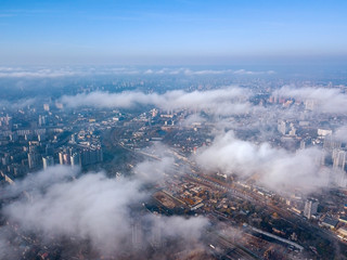 Fototapeta na wymiar Aerial drone cityscape. Kiev city houses under rare clouds, top view.