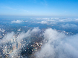 Aerial drone cityscape. Kiev city houses under rare clouds, top view.