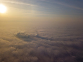 Fototapeta na wymiar Aerial drone flight above clouds