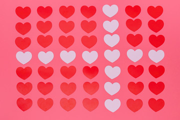 a lot of red small hearts put entire a picture and white small hearts put in a cross pattern, those are put on a pink background