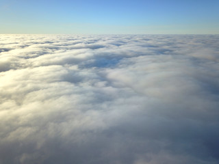 Fototapeta na wymiar Aerial drone view. Flying above the clouds