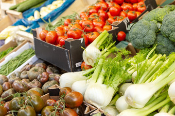Fresh raw organic bio uncooked vegetables for sale at farmers market. Broccoli, tomatoes, fennel at market, stock photo. Vegan food and healthy nutrition concept. Different types vegetables at market.