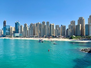 Turquoise water, beach and buildings of Dubai