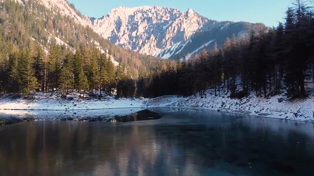 Aerial  landscape of Gruner See, famous green lake in Tragoss, Styria, Austria. Travel destination. View at mountains and forests surrounding the frozen lake.