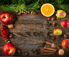 Spices with fruits, berries and nuts on a old wooden background. Autumn background, Christmas...