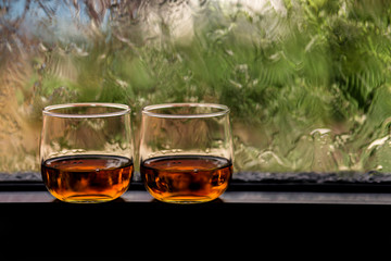 a glass of whiskey on wood bar, soft focus.