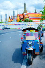 asia local travel in city activity with local taxi (tuk tuk) parking for wait tourism on street of bangkok Thailand with grandpalace landmark background