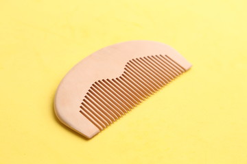 wooden comb in color background
