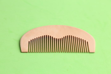 wooden comb in color background