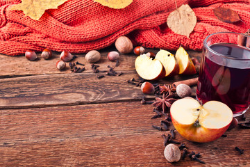 Christmas hot mulled wine with spices and fruits on a old wooden background. Autumn background, Christmas background. Text space.