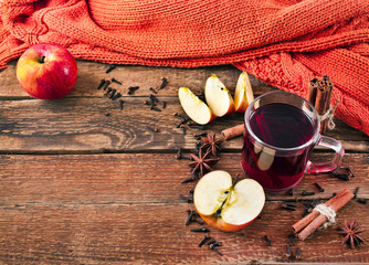 Christmas hot mulled wine with spices and fruits on a old wooden background. Autumn background, Christmas background. Text space.