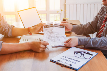 Businessmen who are stressed due to bankruptcy and are tearing the contract in front of the lawyer in the lawyer office.