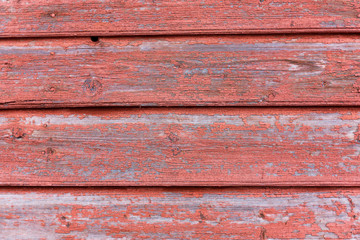 A part of an old wooden shed with peeling paint. Background