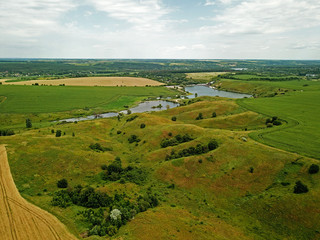 Aerial drone view. Lake among the fields
