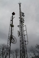 Telecom towers with gray skies