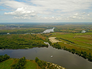 Aeiral drone view. Green banks of the Dnieper River near Kiev in cloudy weather on the outskirts of the city.