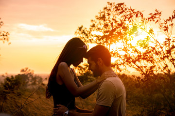 Silhouette of couple love had hug with beautiful sunset background. Travel with my love concept.