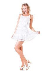 Young slim beautiful blond woman in white sexy mini dress standing and smiling over white background