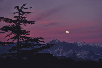 Moon at sunset on the Apuan Alps Liguria Italy