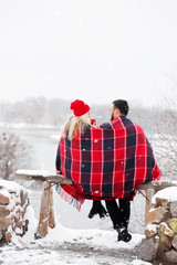 Young couple at a picnic in winter they drink coffee