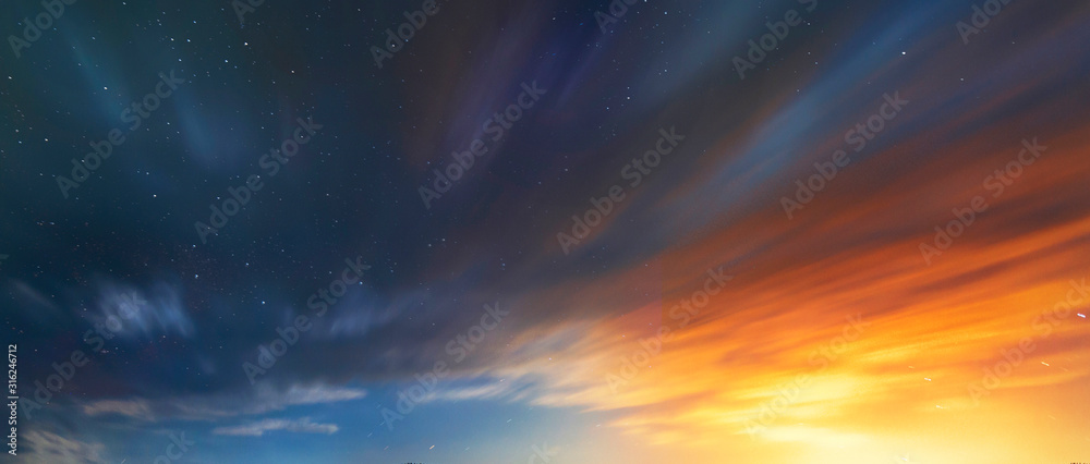 Wall mural Long exposure clouds at the starry sky. Bright moon light behind the colorful clouds. Night photography. Astronomical background.