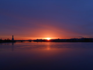 Bright colorful sunrise or sunset in Saint-Petersburg. Landscape. Neva river and sea
