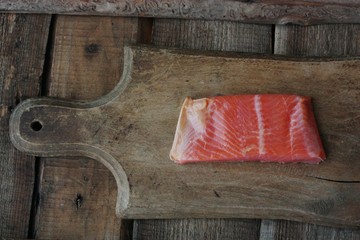 Fresh fish fillet on a wooden table