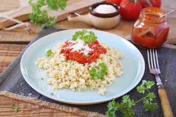 Pearl barley with tomato sauce and grated parmesan cheese
