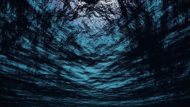 A view up to the ocean surface from deep underwater.