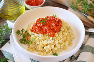 Pearl barley with tomato sauce and grated parmesan cheese