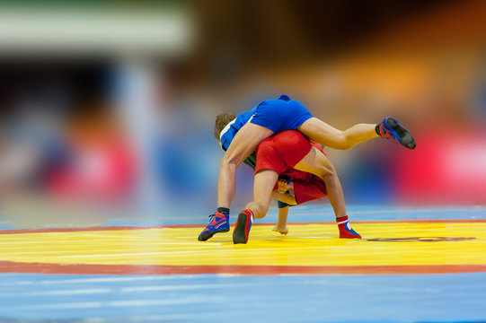 Unrecognizable sambo wrestlers fighting