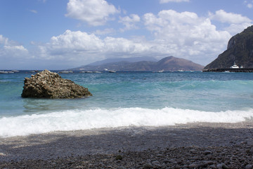 Fototapeta na wymiar blue sea water summer beach with island rocks sky clouds panoramic view