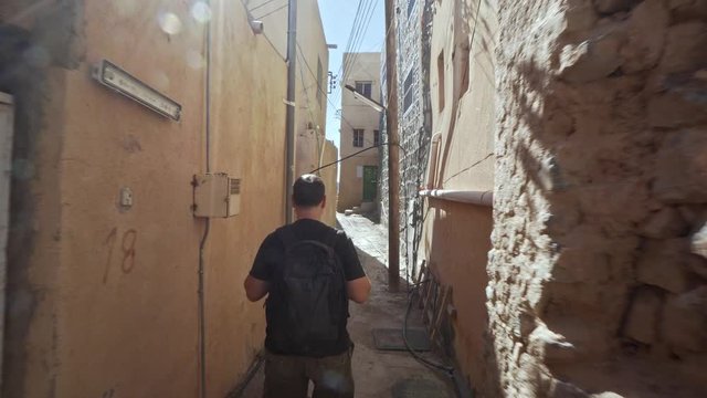 Young Man Visiting Abandoned Old Ruined Village of Al Hamra near Nizwa, Oman