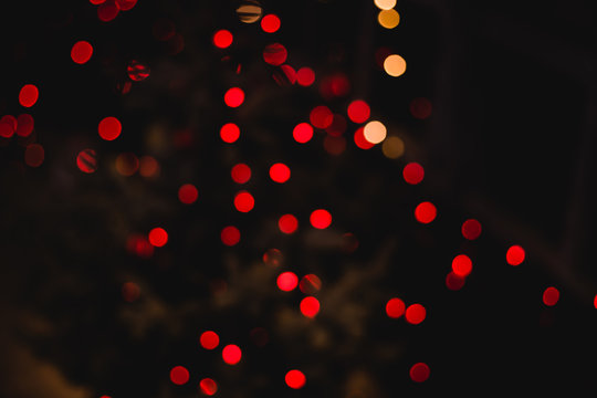 Holidays abstract glitter background. Red blur abstract bokeh light backgound form christmas night or valentine day