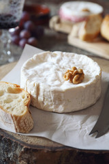 French dessert. Camembert cheese, baguette, red wine and red grapes