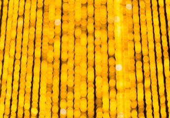 Yellow bokeh balls background. Golden holiday glowing backdrop. Defocused Background With Blinking Stars.