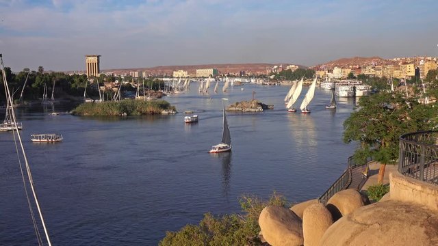 Beautiful landscape with felucca boats on Nile river in Aswan at sunset, Egypt, 4k