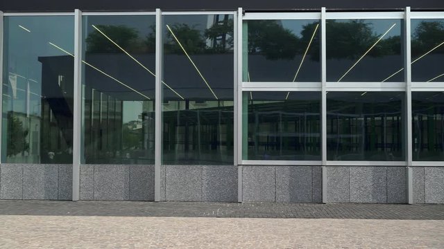 Gimbal pan shot of contemporary business building outdoors in summer in Italy, prada foundation. Italian contemporary business building outdoors in summer time
