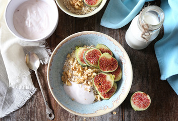 Oatmeal, yogurt, ripe figs, walnutsin bowl and milk